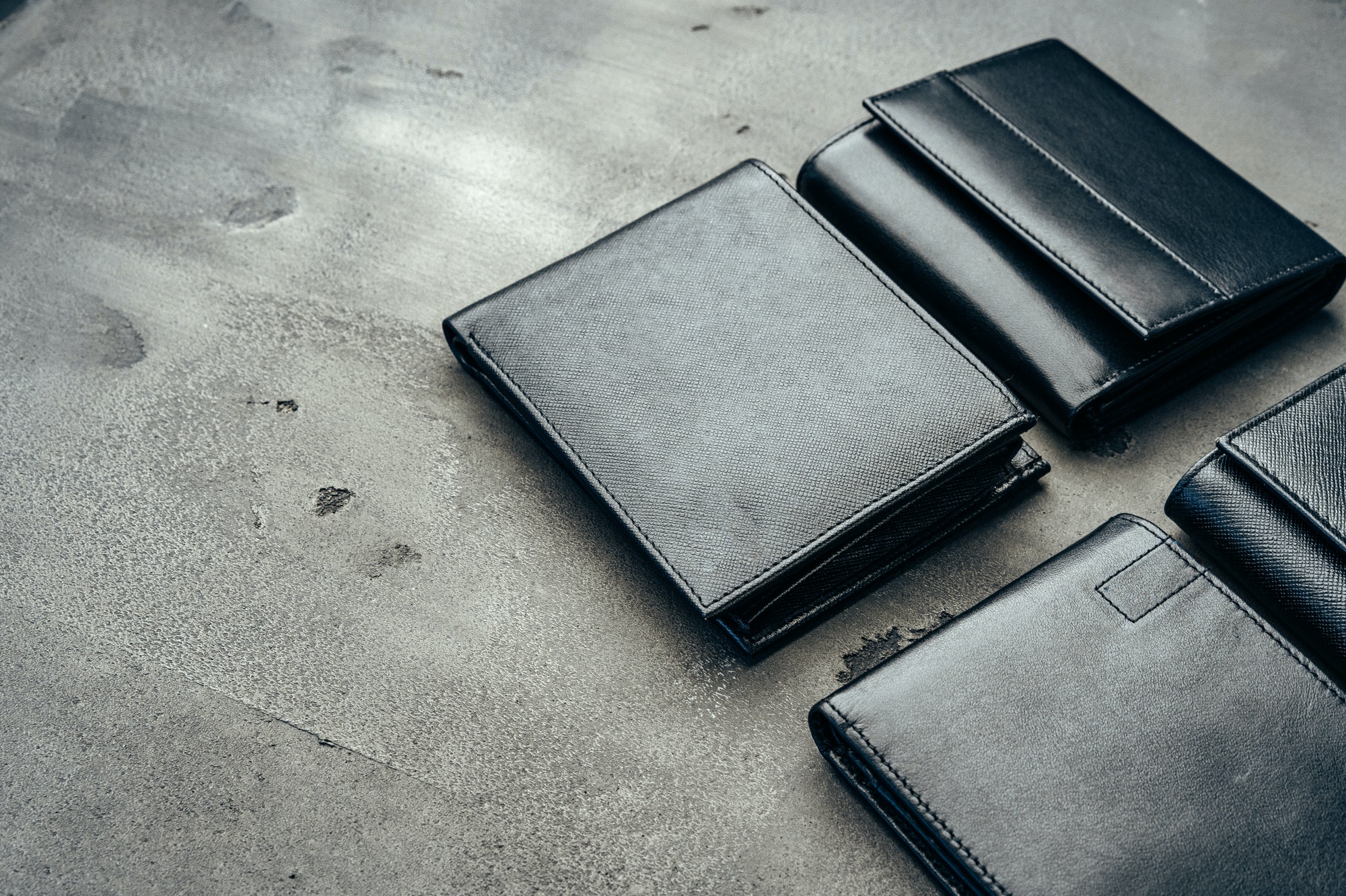 Male leather wallets on grey concrete background